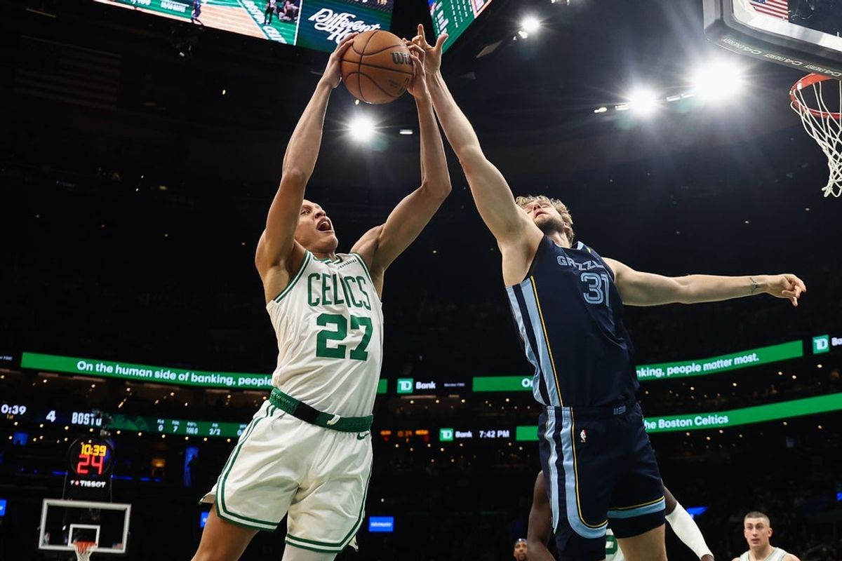 Nov 12, 2025; Boston, Massachusetts, USA; Boston Celtics guard Jordan Walsh (27) grabs a rebound away from Memphis Grizzlies center Jock Landale (31) during the first quarter at TD Garden. Mandatory Credit: Winslow Townson-Imagn Images