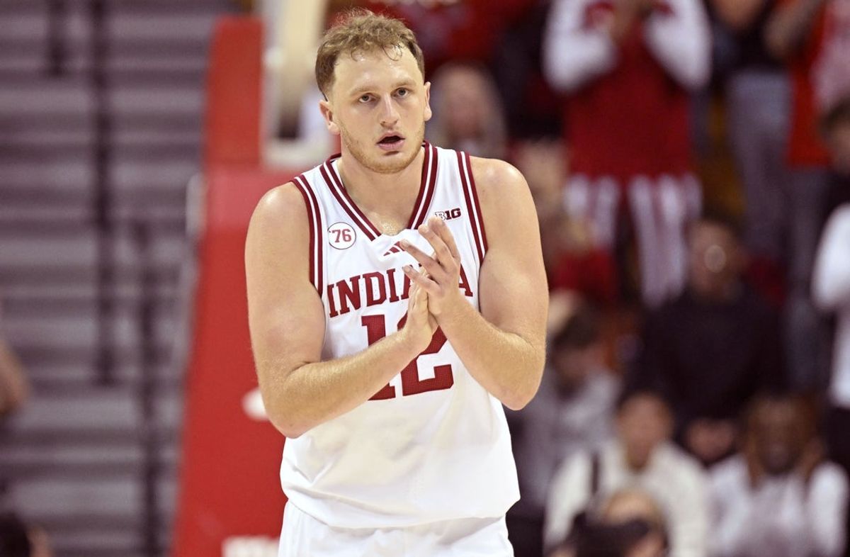 Nov 12, 2025; Bloomington, Indiana, USA; Indiana Hoosiers forward Tucker Devries (12) celebrates after a play during the first half against the Milwaukee Panthers at Simon Skjodt Assembly Hall. Mandatory Credit: Robert Goddin-Imagn Images