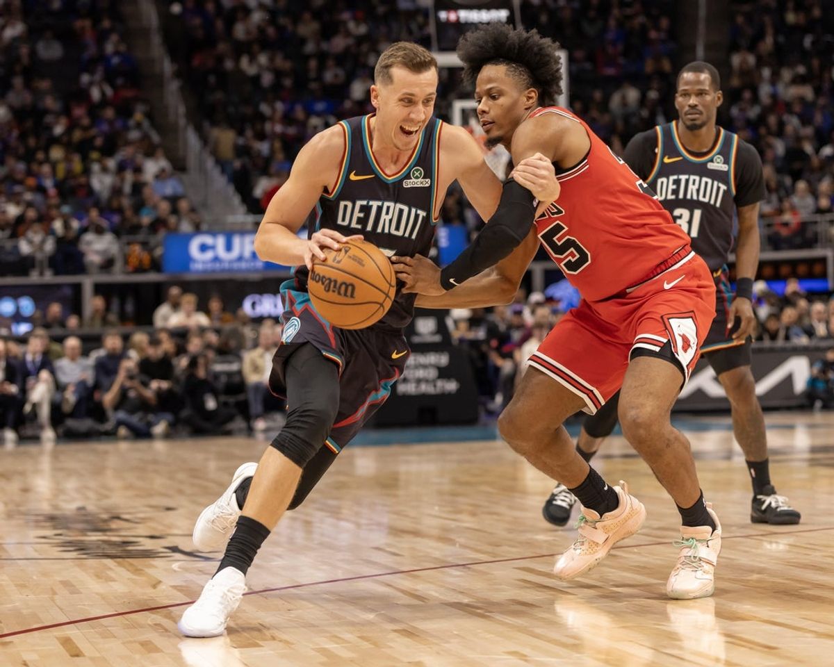 Nov 12, 2025; Detroit, Michigan, USA; Chicago Bulls forward Isaac Okoro (35) defends against Detroit Pistons forward Duncan Robinson (55) during the second quarter at Little Caesars Arena. Mandatory Credit: David Reginek-Imagn Images