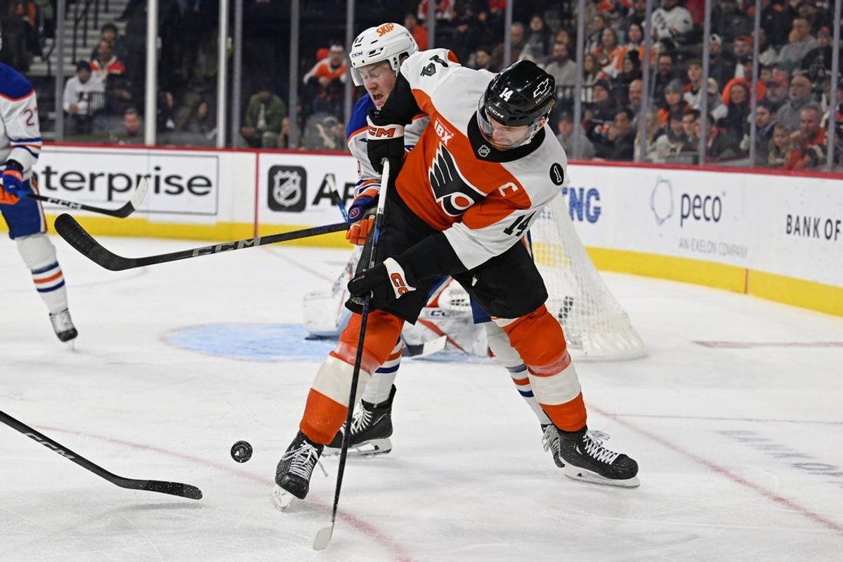 Nov 12, 2025; Philadelphia, Pennsylvania, USA; Philadelphia Flyers center Sean Couturier (14) and Edmonton Oilers defenseman Ty Emberson (49) battle for the puck during the first period at Xfinity Mobile Arena. Mandatory Credit: Eric Hartline-Imagn Images
