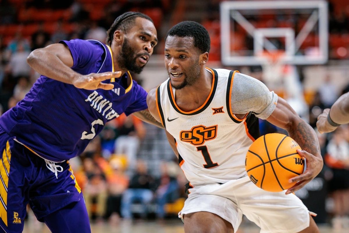Nov 12, 2025; Stillwater, Oklahoma, USA; Oklahoma State Cowboys guard Kanye Clary (1) drives to the basket around Prairie View A&M Panthers guard Doug Young (5) during the first half at Gallagher-Iba Arena. Mandatory Credit: William Purnell-Imagn Images