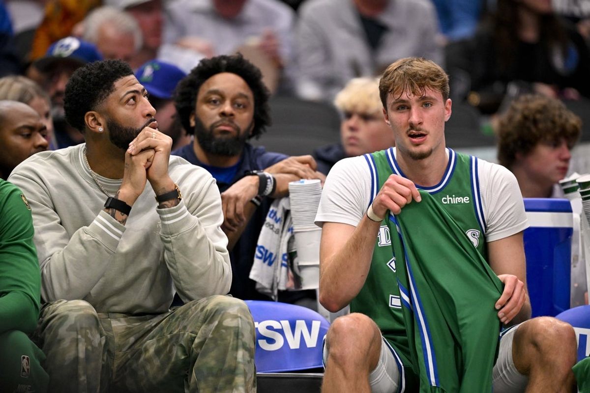 Nov 12, 2025; Dallas, Texas, USA; Dallas Mavericks forward Anthony Davis (left) and forward Cooper Flagg (32) look on during the first quarter against the Phoenix Suns at the American Airlines Center. Mandatory Credit: Jerome Miron-Imagn Images