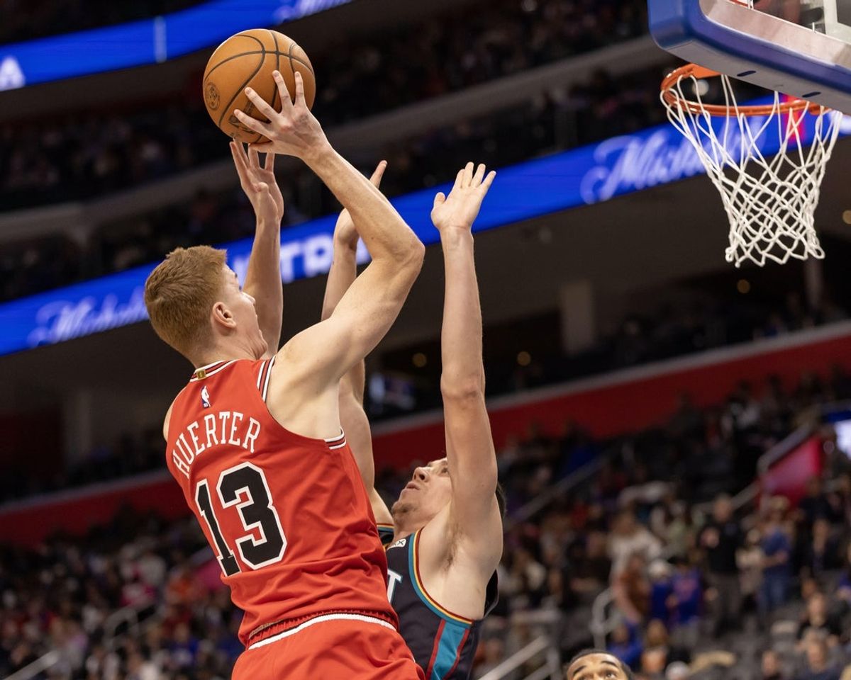 Nov 12, 2025; Detroit, Michigan, USA; Detroit Pistons forward Duncan Robinson (55) defends against Chicago Bulls guard Kevin Huerter (13) during the second half at Little Caesars Arena. Mandatory Credit: David Reginek-Imagn Images