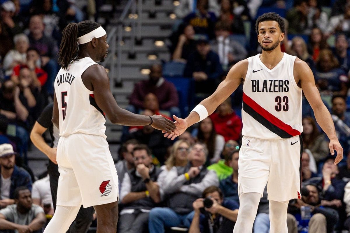 Nov 12, 2025; New Orleans, Louisiana, USA;  Portland Trail Blazers guard Jrue Holiday (5) slaps hands with Portland forward Toumani Camara (33) after a play against the New Orleans Pelicans during the second half at Smoothie King Center. Mandatory Credit: Stephen Lew-Imagn Images