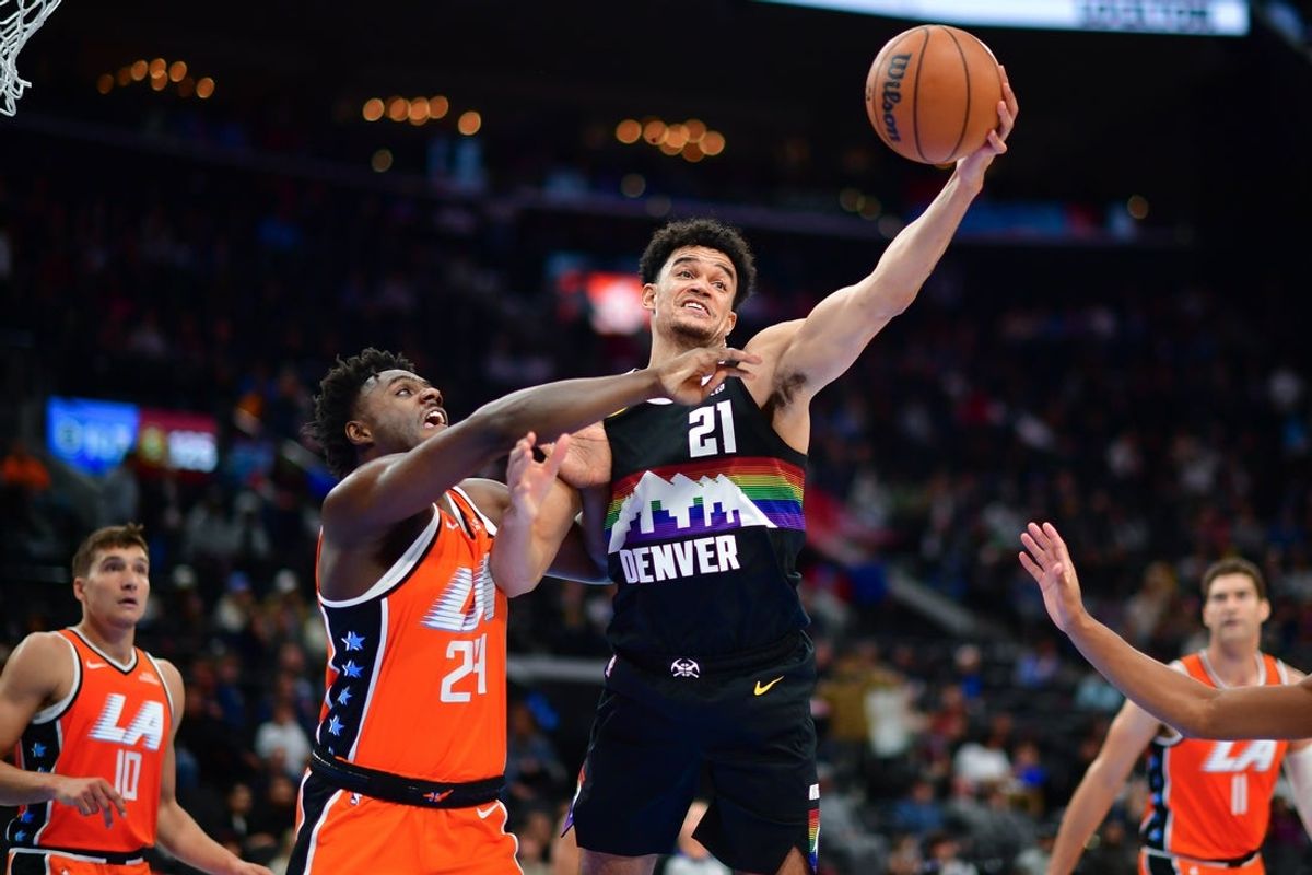 Nov 12, 2025; Inglewood, California, USA; Denver Nuggets forward Spencer Jones (21) plays for the rebound against Los Angeles Clippers guard Kobe Brown (24) during the second half at Intuit Dome. Mandatory Credit: Gary A. Vasquez-Imagn Images