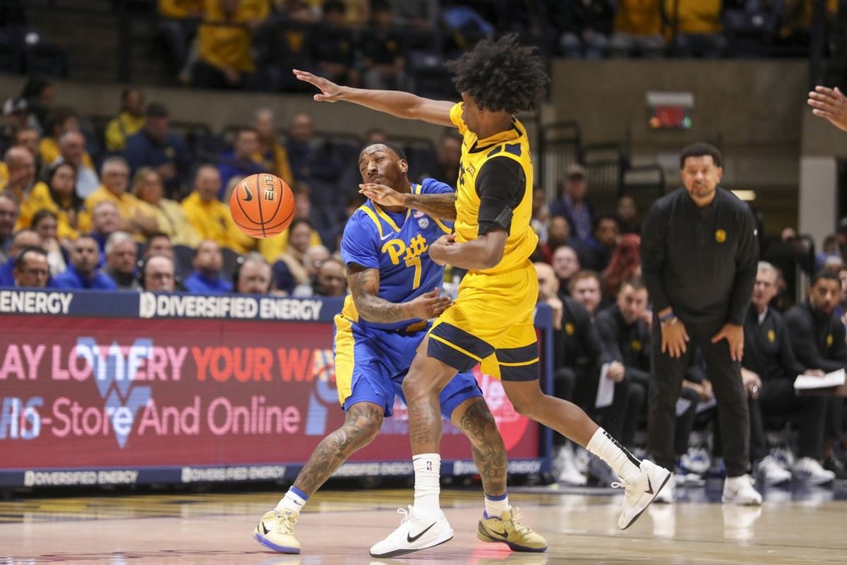 Nov 13, 2025; Morgantown, West Virginia, USA; Pittsburgh Panthers guard Damarco Minor (7) and West Virginia Mountaineers guard Amir Jenkins (2) collide after a loose ball during the first half at WVU Coliseum. Mandatory Credit: Ben Queen-Imagn Images