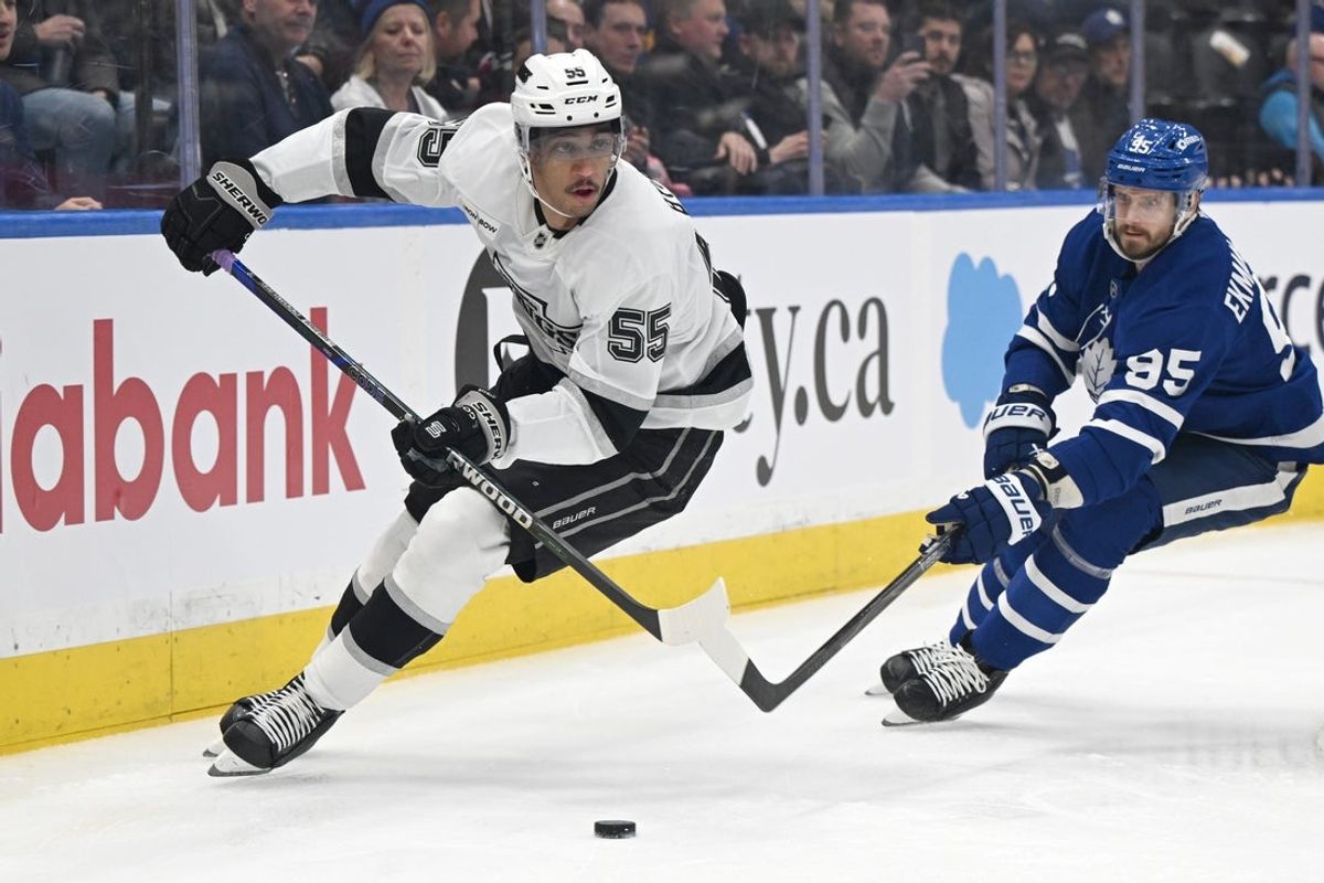 Nov 13, 2025; Toronto, Ontario, CAN;  Los Angeles Kings forward Quintin Byfield (55) skates with the puck past Toronto Maple Leafs defenseman Oliver Ekman-Larsson (95) in the first period at Scotiabank Arena. Mandatory Credit: Dan Hamilton-Imagn Images