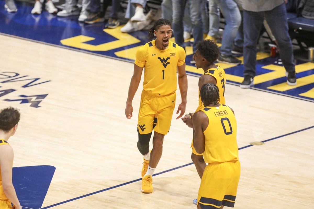 Nov 13, 2025; Morgantown, West Virginia, USA; West Virginia Mountaineers guard Jasper Floyd (1) celebrates with West Virginia Mountaineers guard Honor Huff (3) during the second half against the Pittsburgh Panthers at WVU Coliseum. Mandatory Credit: Ben Queen-Imagn Images