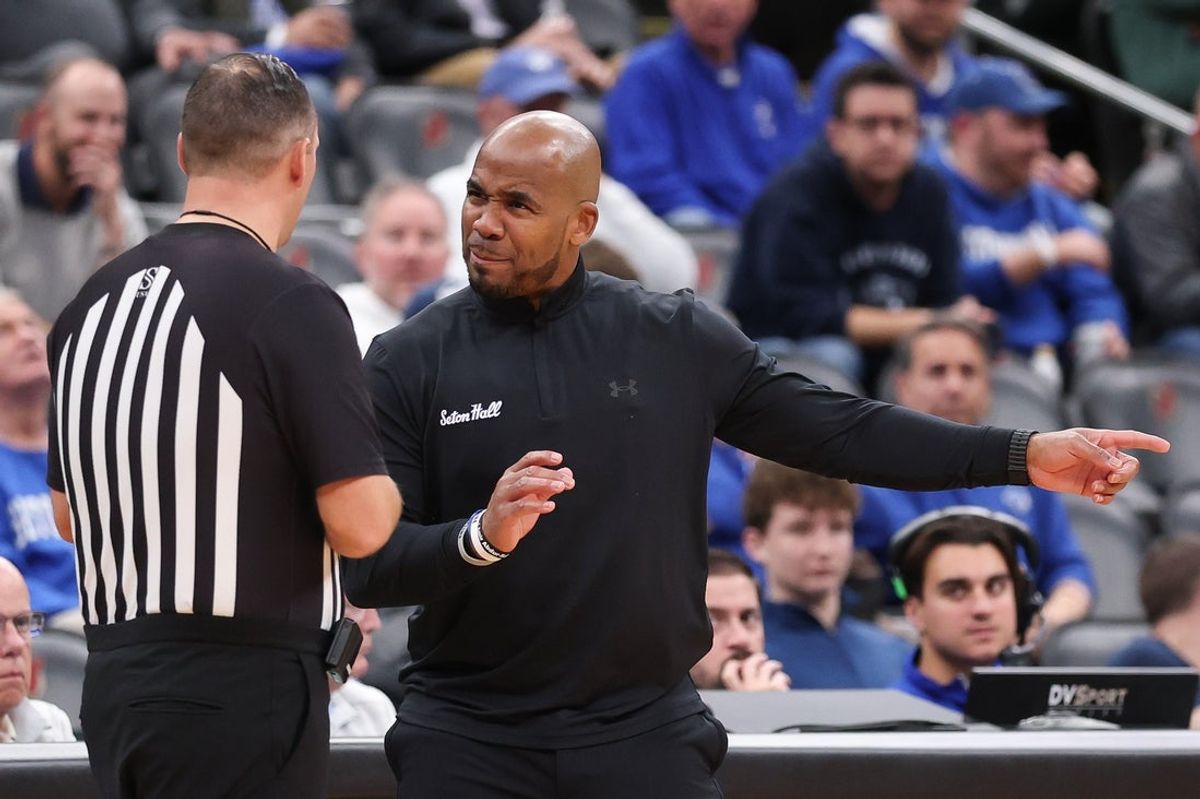 Nov 13, 2025; Newark, New Jersey, USA; Seton Hall Pirates head coach Shaheen Holloway talks with a referee during the second half against the Monmouth Fighting Scots at Prudential Center. Mandatory Credit: Vincent Carchietta-Imagn Images