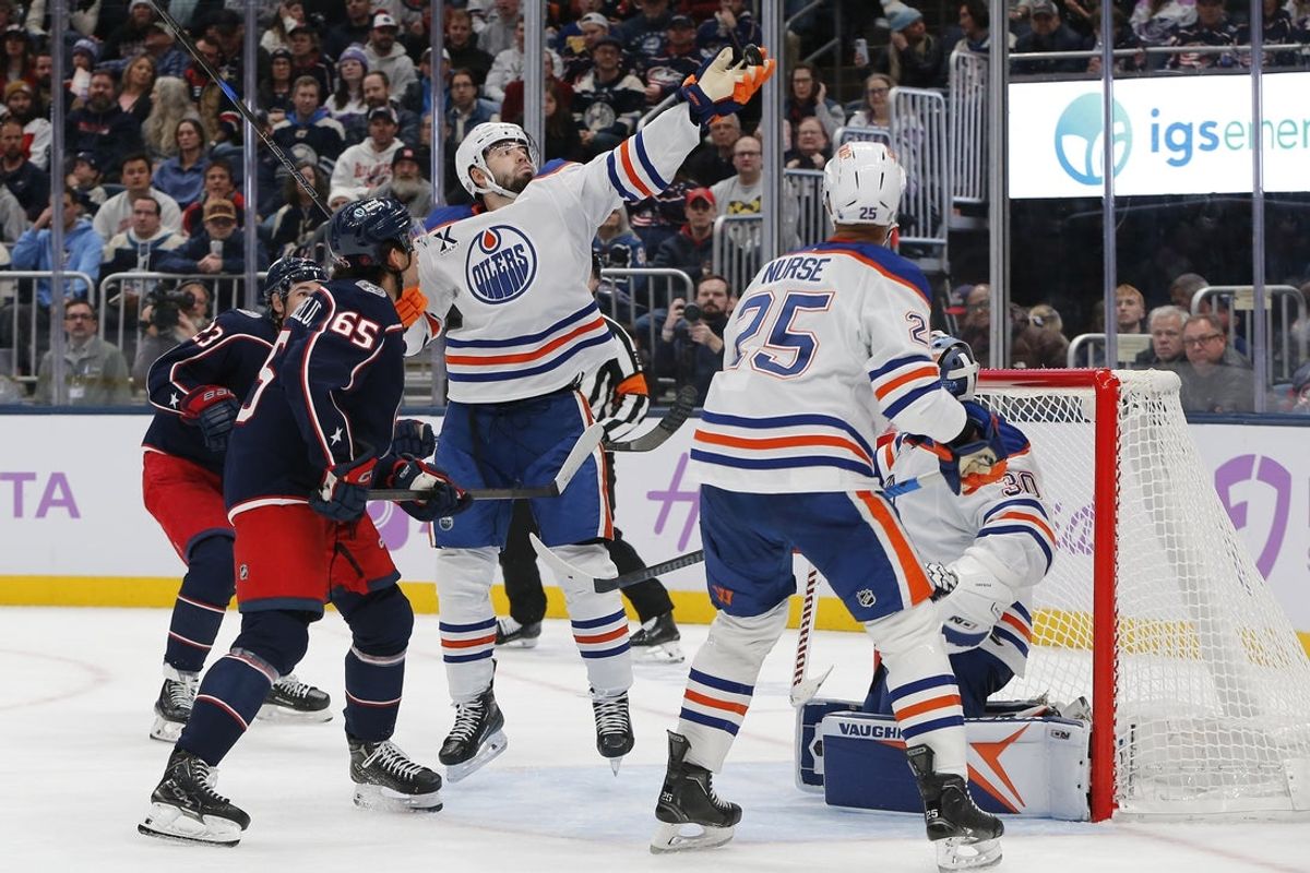 Nov 13, 2025; Columbus, Ohio, USA; Edmonton Oilers defenseman Jake Walman (96) bats the puck away after a save by Calvin Pickard (30) against the Columbus Blue Jackets during the second period at Nationwide Arena. Mandatory Credit: Russell LaBounty-Imagn Images