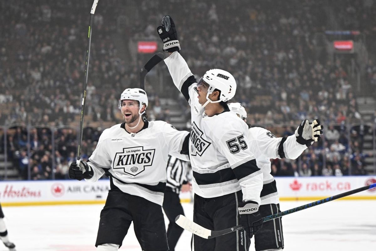 Nov 13, 2025; Toronto, Ontario, CAN;  Los Angeles Kings forward Quintin Byfield (55) celebrates with forward Adrian Kempe (9) and defenseman Drew Doughty (8) after scoring the winning goal in overtime against the Toronto Maple Leafs at Scotiabank Arena. Mandatory Credit: Dan Hamilton-Imagn Images