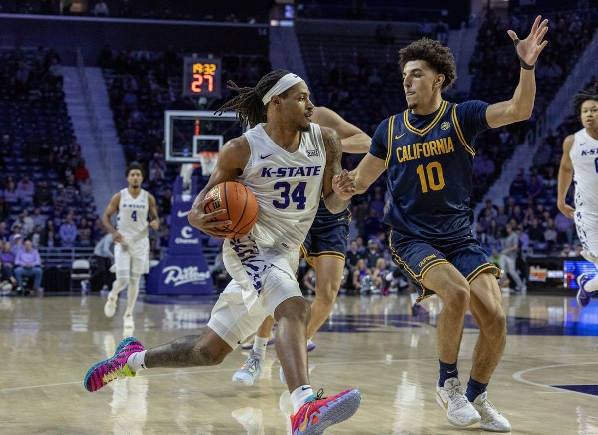 Nov 13, 2025; Manhattan, Kansas, USA; Kansas State Wildcats guard Nate Johnson (34) is guarded by California Golden Bears guard Justin Pippen (10) during the first half at Bramlage Coliseum. Mandatory Credit: Scott Sewell-Imagn Images