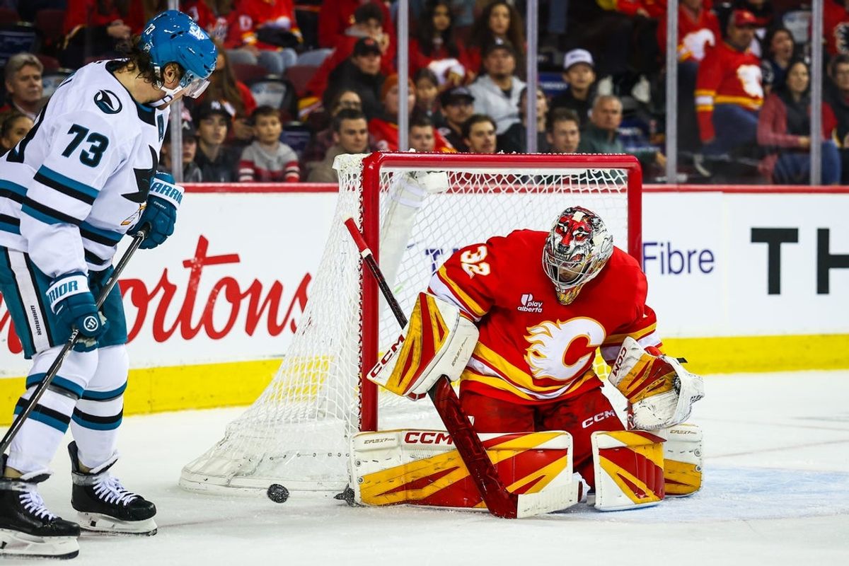 Nov 13, 2025; Calgary, Alberta, CAN; Calgary Flames goaltender Dustin Wolf (32) makes a save against the San Jose Sharks during the third period at Scotiabank Saddledome. Mandatory Credit: Sergei Belski-Imagn Images