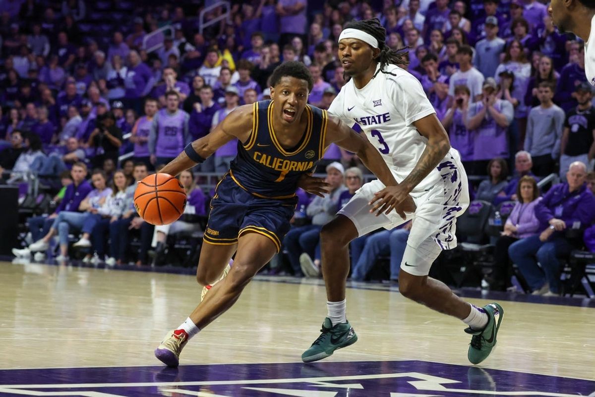 Nov 13, 2025; Manhattan, Kansas, USA; California Golden Bears guard Dai Dai Ames (7) drives against Kansas State Wildcats guard C.J. Jones (3) during the second half at Bramlage Coliseum. Mandatory Credit: Scott Sewell-Imagn Images