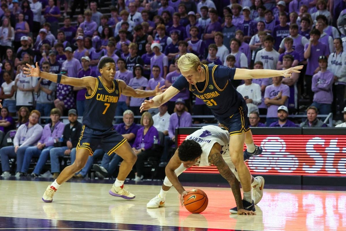 Nov 13, 2025; Manhattan, Kansas, USA; Kansas State Wildcats guard P.J. Haggerty (4) tries to keep the ball from California Golden Bears forward Rytis Petraitis (31) and guard Dai Dai Ames (7) during the second half at Bramlage Coliseum. Mandatory Credit: Scott Sewell-Imagn Images