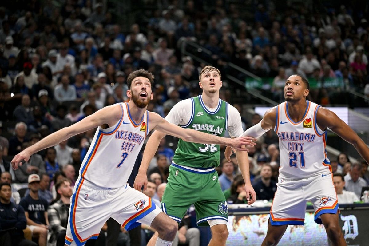 Oct 27, 2025; Dallas, Texas, USA; Oklahoma City Thunder center Chet Holmgren (7) and guard Aaron Wiggins (21) and Dallas Mavericks forward Cooper Flagg (32) look for the ball during the game between the Mavericks and the Thunder at the American Airlines Center. Mandatory Credit: Jerome Miron-Imagn Images