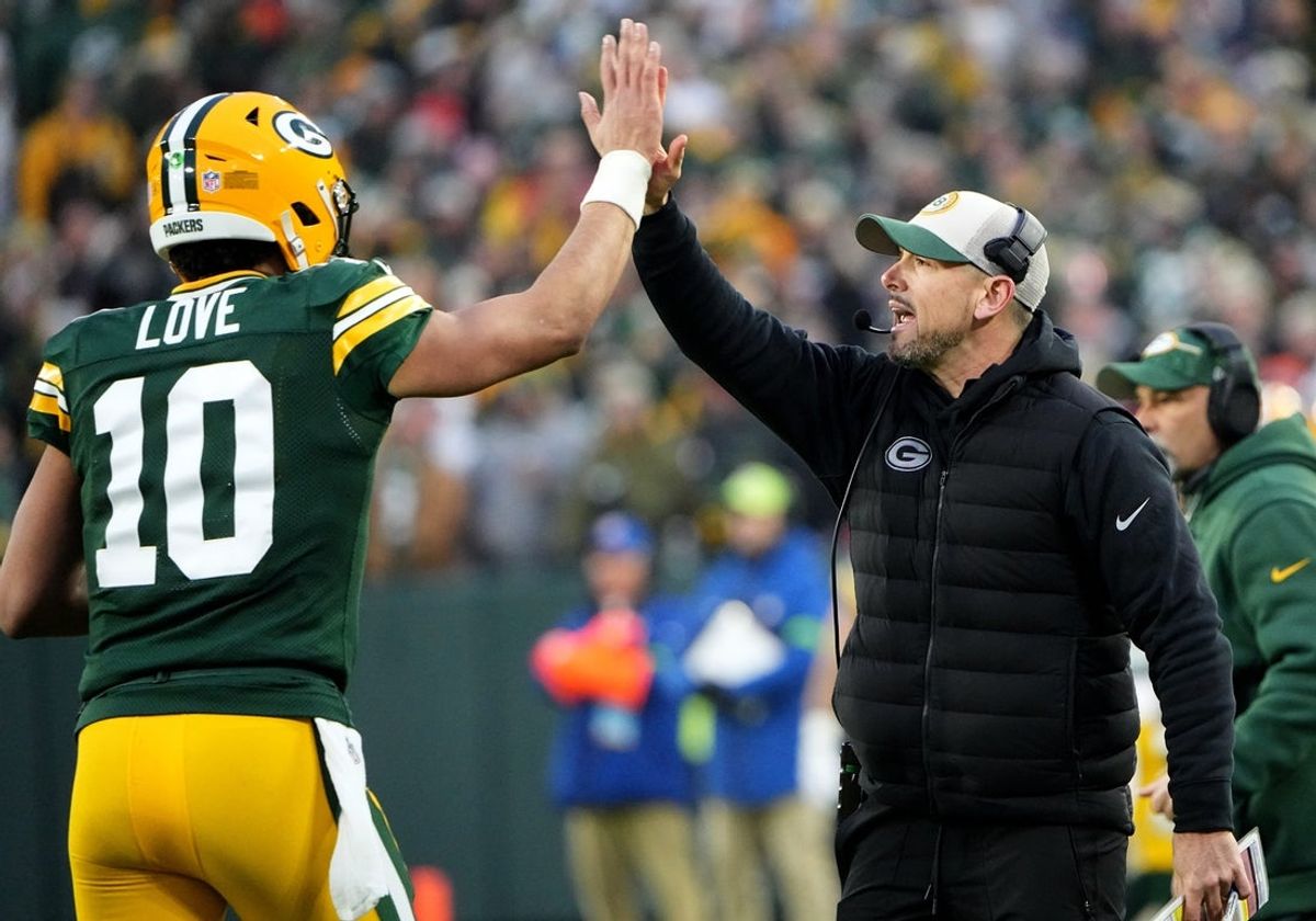 Green Bay Packers quarterback Jordan Love (10) high fives head coach Matt LaFleur after throwing a touchdown pass during the second quarter of their game against the Chicago Bear Sunday, January 7, 2024 at Lambeau Field in Green Bay, Wisconsin.Mark Hoffman/Milwaukee Journal Sentinel