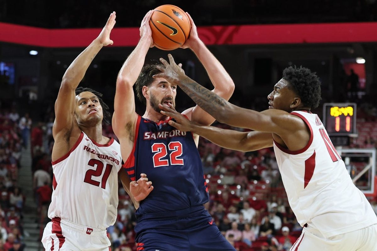 Nov 14, 2025; Fayetteville, Arkansas, USA; Samford Bulldogs forward Jaxon Pollard (22) looks to pass as Arkansas Razorbacks guard D.J. Wagner (21) and wine Karter Knox (11) defend during the first half at Bud Walton Arena. Mandatory Credit: Nelson Chenault-Imagn Images