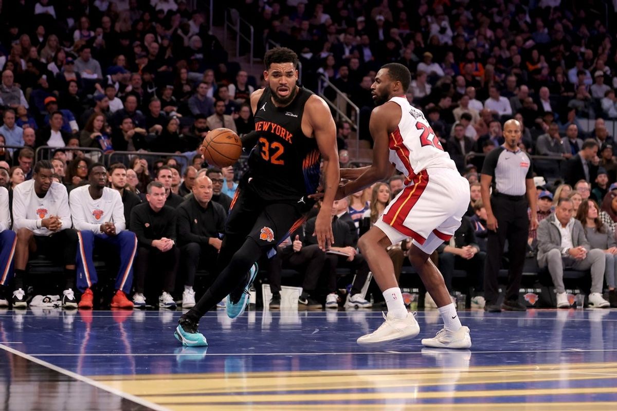 Nov 14, 2025; New York, New York, USA; New York Knicks center Karl-Anthony Towns (32) drives to the basket against Miami Heat forward Andrew Wiggins (22) during the second quarter at Madison Square Garden. Mandatory Credit: Brad Penner-Imagn Images
