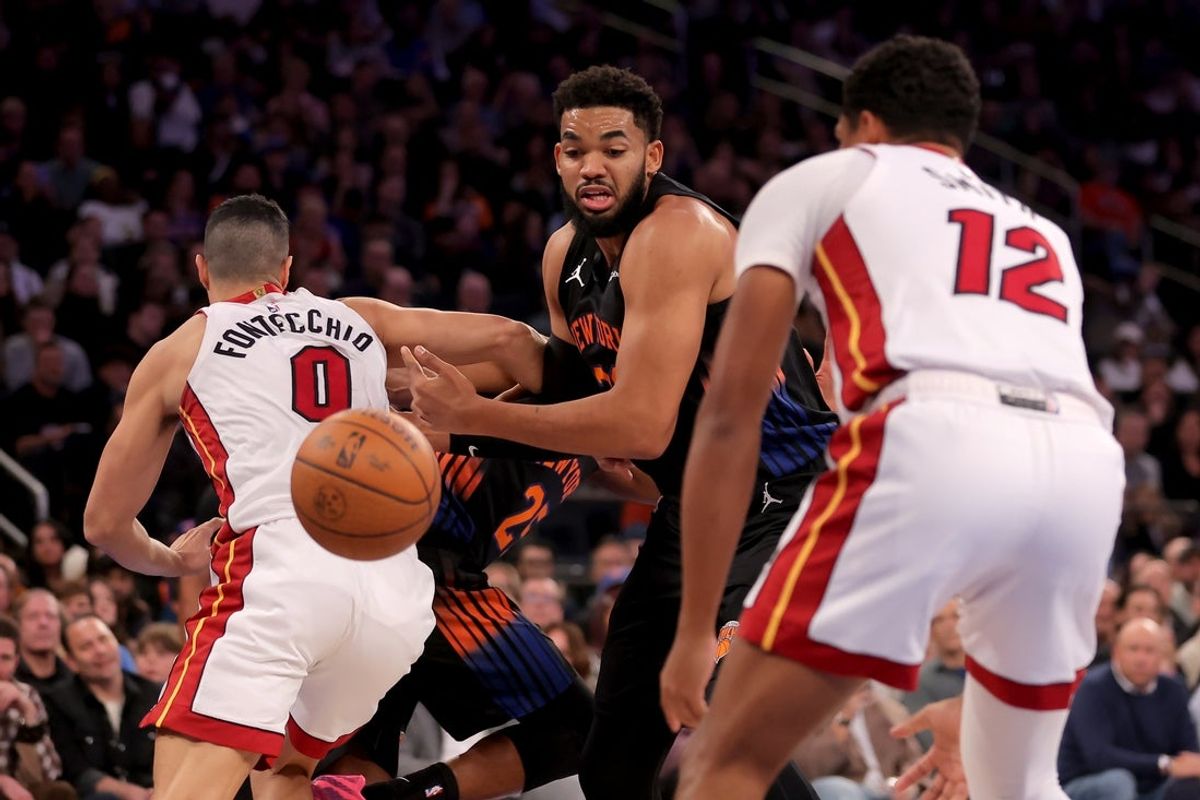 Nov 14, 2025; New York, New York, USA; New York Knicks center Karl-Anthony Towns (32) fights for a rebound against Miami Heat forward Simone Fontecchio (0) and guard Dru Smith (12) during the first quarter at Madison Square Garden. Mandatory Credit: Brad Penner-Imagn Images