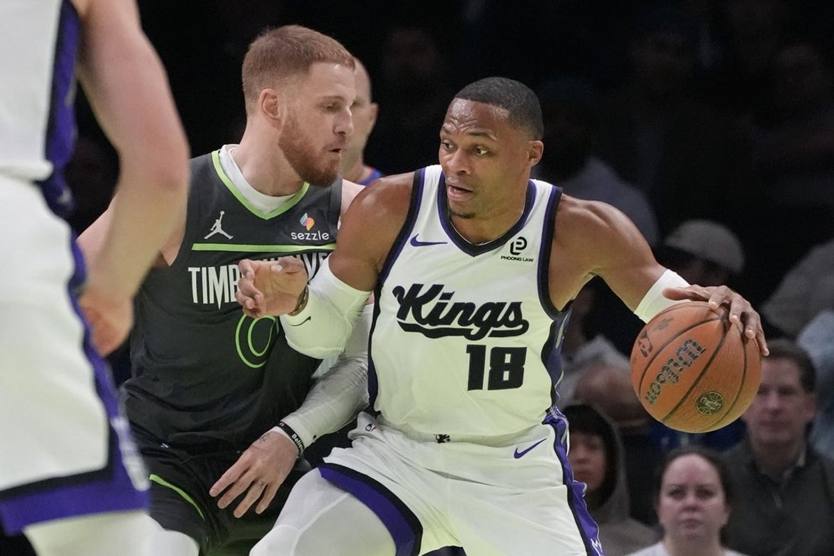 Nov 14, 2025; Minneapolis, Minnesota, USA; Sacramento Kings guard Russell Westbrook (18) works around Minnesota Timberwolves guard Donte DiVincenzo (0) in the first quarter at Target Center. Mandatory Credit: Bruce Kluckhohn-Imagn Images