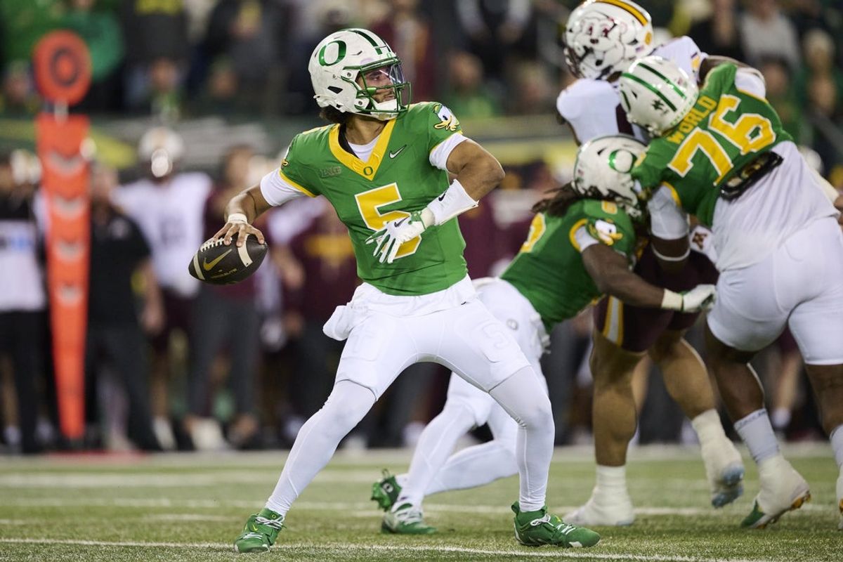 Nov 14, 2025; Eugene, Oregon, USA; Oregon Ducks quarterback Dante Moore (5) throws a pass for a first down during the first half against the Minnesota Golden Gophers at Autzen Stadium. Mandatory Credit: Troy Wayrynen-Imagn Images