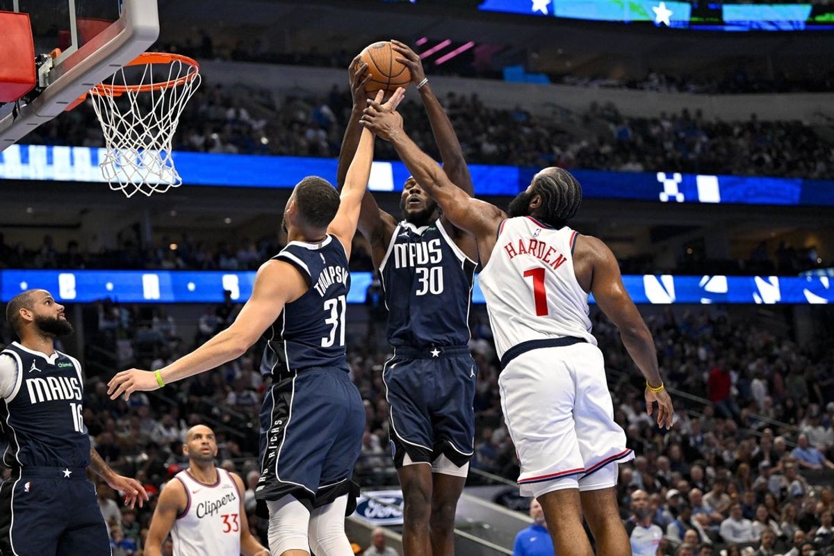 Nov 14, 2025; Dallas, Texas, USA; Dallas Mavericks center Moussa Cisse (30) grabs a rebound in front of LA Clippers guard James Harden (1) and guard Klay Thompson (31) during the second quarter in an NBA Cup game at the American Airlines Center. Mandatory Credit: Jerome Miron-Imagn Images
