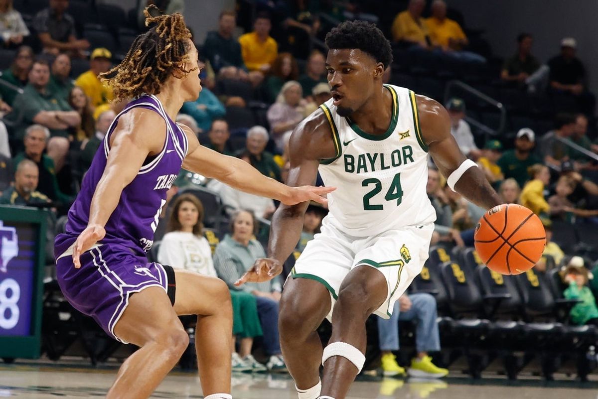 Nov 14, 2025; Waco, Texas, USA; Baylor Bears guard Tounde Yessoufou (24) controls the ball as Tarleton State Texans guard Jordan Mizell (0) defends during the first half at Paul and Alejandra Foster Pavilion. Mandatory Credit: Chris Jones-Imagn Images