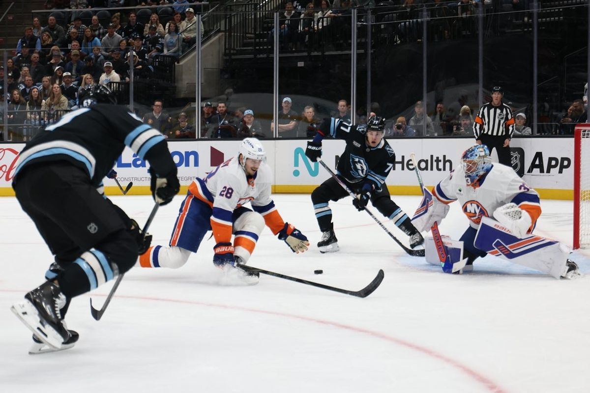 Nov 14, 2025; Salt Lake City, Utah, USA; Utah Mammoth right wing JJ Peterka (77) takes a pass from left wing Lawson Crouse (67) to score a goal against New York Islanders defenseman Alexander Romanov (28) and goaltender David Rittich (33) during the first period at Delta Center. Mandatory Credit: Rob Gray-Imagn Images