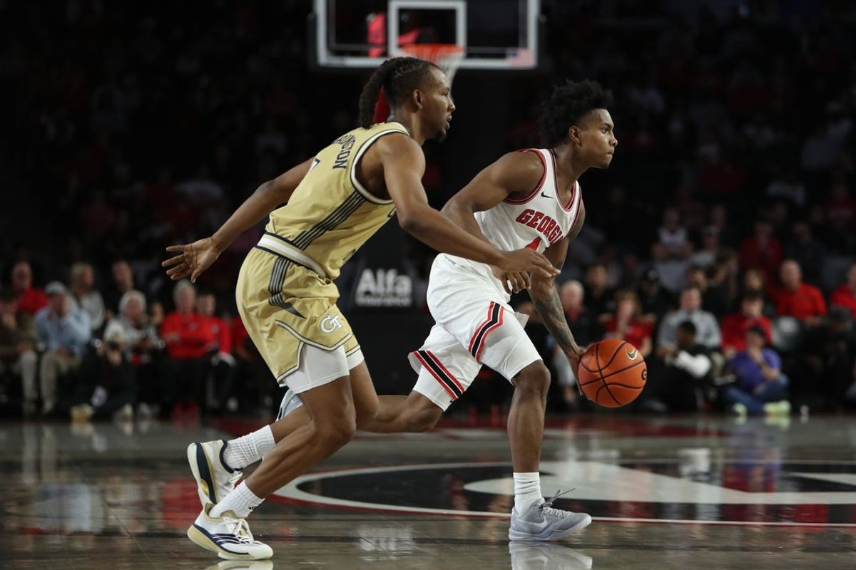 Nov 14, 2025; Athens, Georgia, USA; Georgia Bulldogs guard Marcus Millender (4) dribbles past Georgia Tech Yellow Jackets guard Lamar Washington (1) during the first half at Stegeman Coliseum. Mandatory Credit: Mady Mertens-Imagn Images