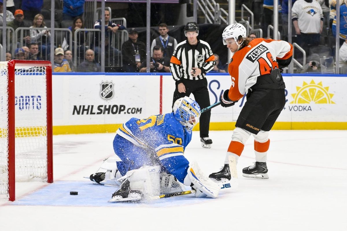 Nov 14, 2025; St. Louis, Missouri, USA; Philadelphia Flyers center Trevor Zegras (46) scores against St. Louis Blues goaltender Jordan Binnington (50) in shootouts at Enterprise Center. Mandatory Credit: Jeff Curry-Imagn Images