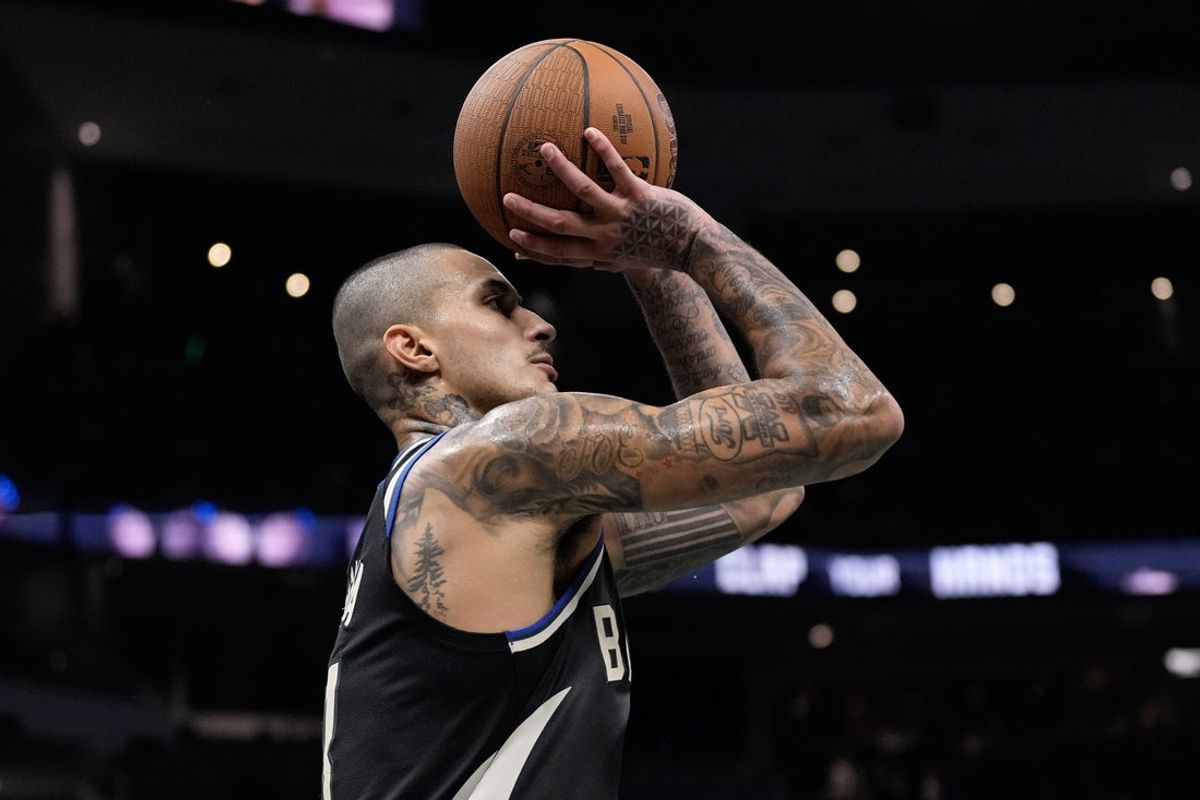 Nov 14, 2025; Milwaukee, Wisconsin, USA;  Milwaukee Bucks forward Kyle Kuzma (18) shoots during overtime against the Charlotte Hornets at Fiserv Forum. Mandatory Credit: Jeff Hanisch-Imagn Images