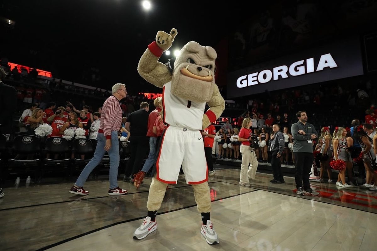 Nov 14, 2025; Athens, Georgia, USA; Georgia Bulldogs mascot Hairy Dawg holds up a one after a game against the Georgia Tech Yellow Jackets at Stegeman Coliseum. Mandatory Credit: Mady Mertens-Imagn Images