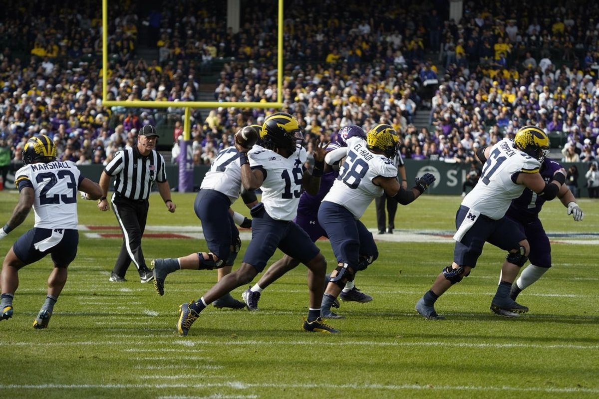 Nov 15, 2025; Chicago, Illinois, USA; Michigan Wolverines quarterback Bryce Underwood (19) throws the ball against the Northwestern Wildcats during the first half at Wrigley Field. Mandatory Credit: David Banks-Imagn Images