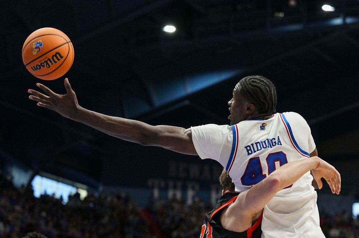 Nov 15, 2025; Lawrence, Kansas, USA; Kansas Jayhawks forward Flory Bidunga (40) grabs a rebound over Princeton Tigers guard Jackson Hicke (33) during the first half at Allen Fieldhouse. Mandatory Credit: Jay Biggerstaff-Imagn Images