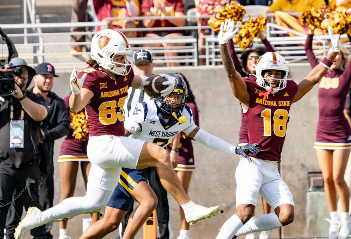 Arizona State Sun Devils Derek Eusebio (83) jumps to score a touchdown against the West Virginia Mountaineers during a game at Mountain America Stadium in Tempe on Nov. 15, 2025.