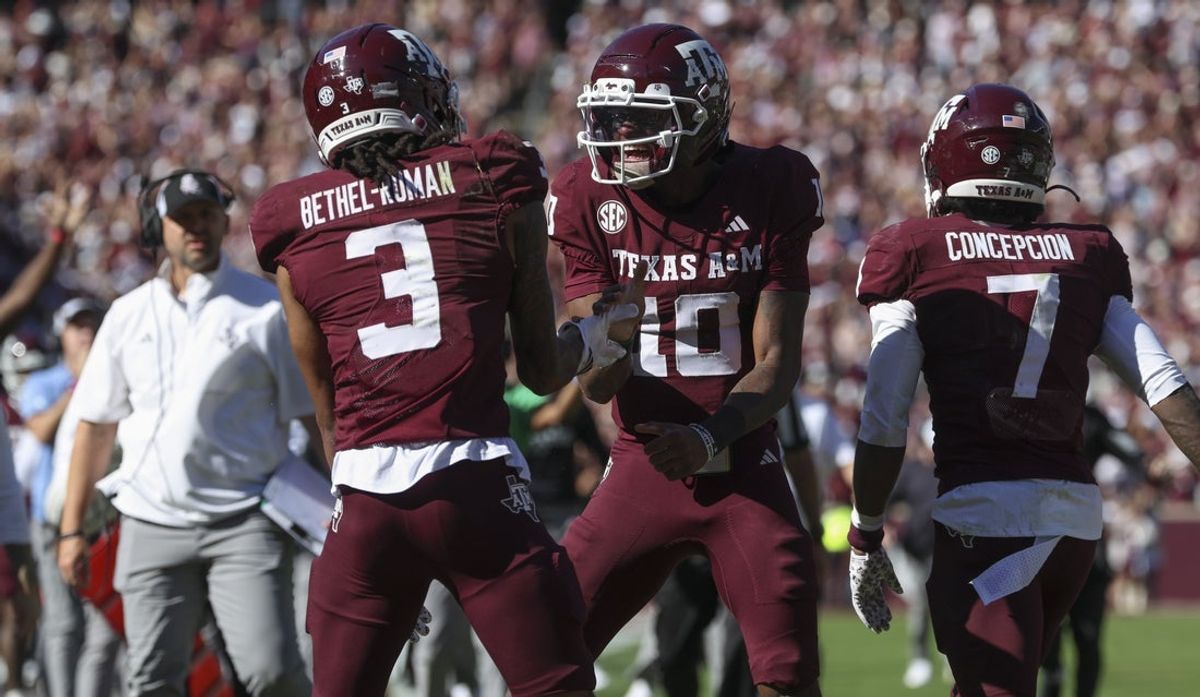Nov 15, 2025; College Station, Texas, USA; Texas A&M Aggies quarterback Marcel Reed (10) celebrates with wide receiver Ashton Bethel-Roman (3) after a touchdown during the third quarter against the South Carolina Gamecocks at Kyle Field. Mandatory Credit: Troy Taormina-Imagn Images