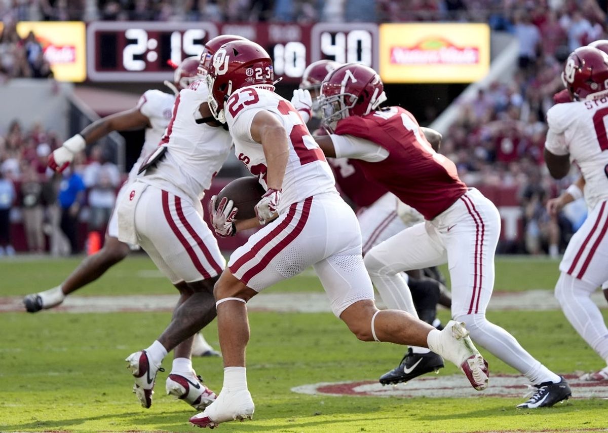 Nov 15, 2025; Tuscaloosa, Alabama, USA;  Oklahoma Sooners defensive back Eli Bowen (23) runs a interception back for a touchdown during the first half against the Alabama Crimson Tide at Saban Field at Bryant-Denny Stadium. Mandatory Credit: Gary Cosby-Imagn Images