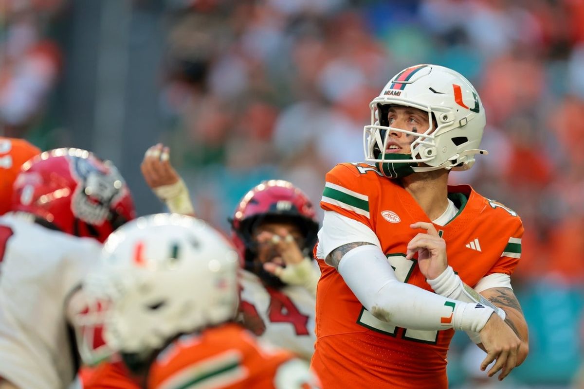Nov 15, 2025; Miami Gardens, Florida, USA; Miami Hurricanes quarterback Carson Beck (11) watches his pass against NC State Wolfpack during the second quarter at Hard Rock Stadium. Mandatory Credit: Sam Navarro-Imagn Images
