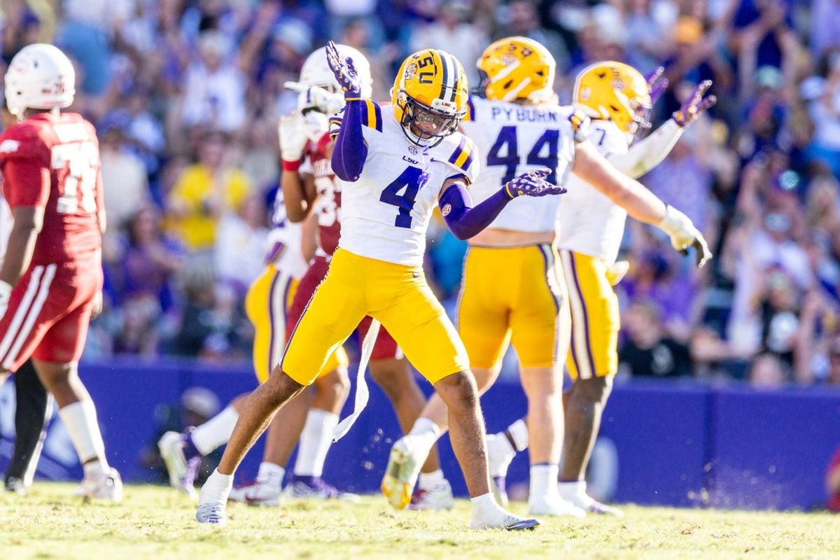 Nov 15, 2025; Baton Rouge, Louisiana, USA;  LSU Tigers cornerback Mansoor Delane (4) reacts to a stop on fourth down against the Arkansas Razorbacks during the second half at Tiger Stadium. Mandatory Credit: Stephen Lew-Imagn Images
