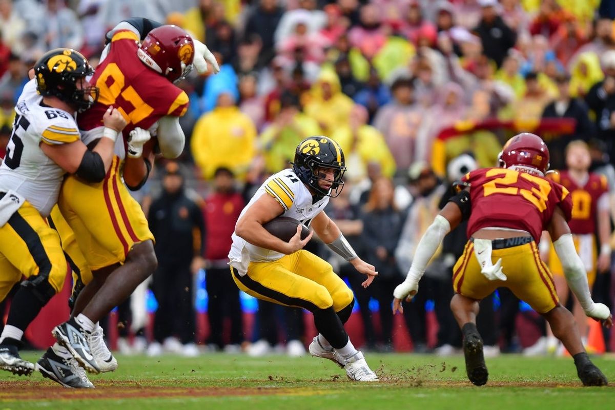 Nov 15, 2025; Los Angeles, California, USA; Iowa Hawkeyes quarterback Mark Gronowski (11) runs the ball against the Southern California Trojans during the second half at the Los Angeles Memorial Coliseum. Mandatory Credit: Gary A. Vasquez-Imagn Images