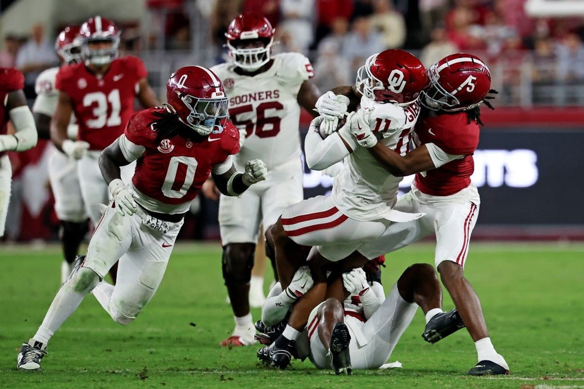 Nov 15, 2025; Tuscaloosa, Alabama, USA;  Oklahoma Sooners wide receiver Javonnie Gibson (11) is tackled by Alabama Crimson Tide wide receiver Germie Bernard (5) during the fourth quarter at Saban Field at Bryant-Denny Stadium. Mandatory Credit: David Leong-Imagn Images