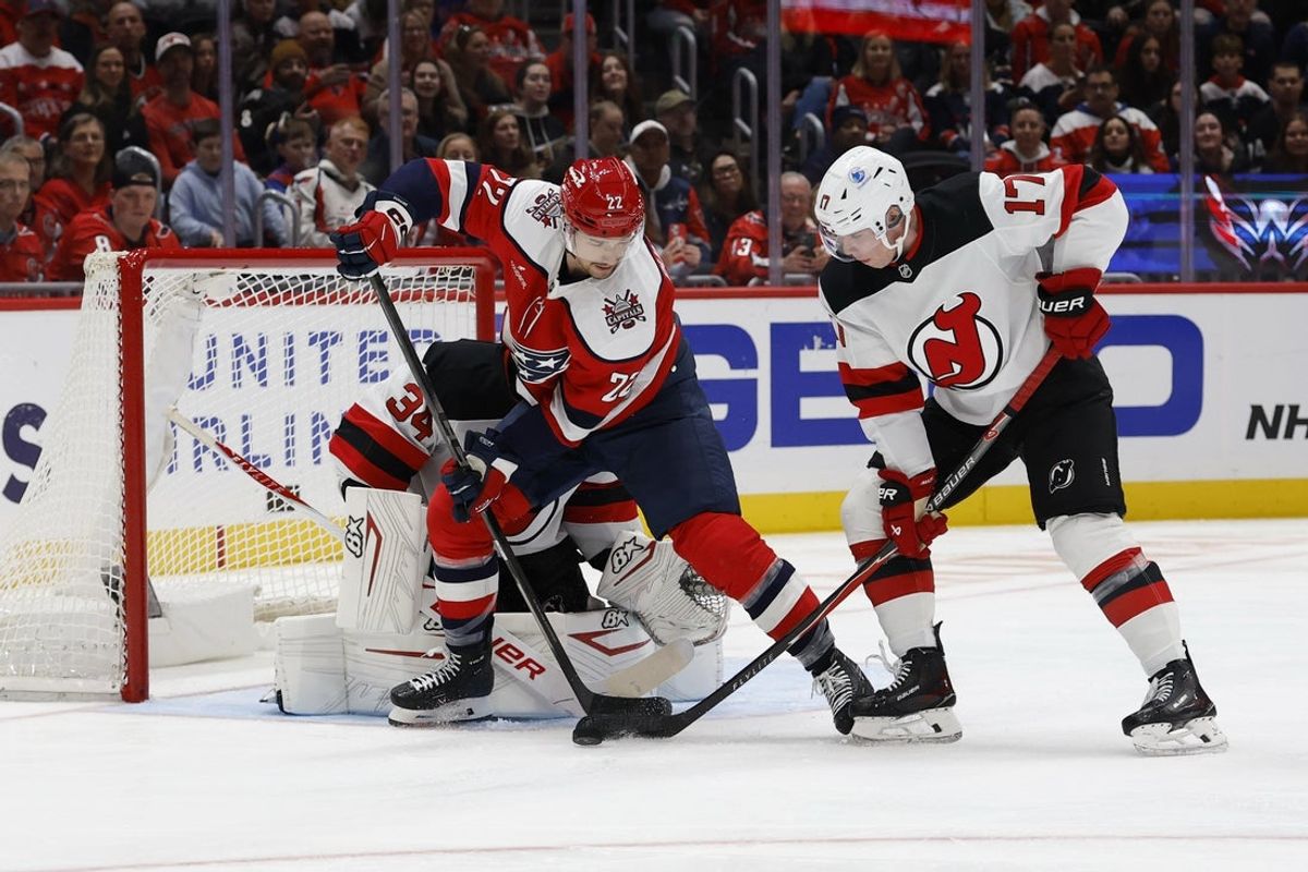 Nov 15, 2025; Washington, District of Columbia, USA; Washington Capitals left wing Anthony Beauvillier (72) and New Jersey Devils defenseman Simon Nemec (17) battle for the puck in front of Devils goaltender Jake Allen (34) during the first period at Capital One Arena. Mandatory Credit: Geoff Burke-Imagn Images