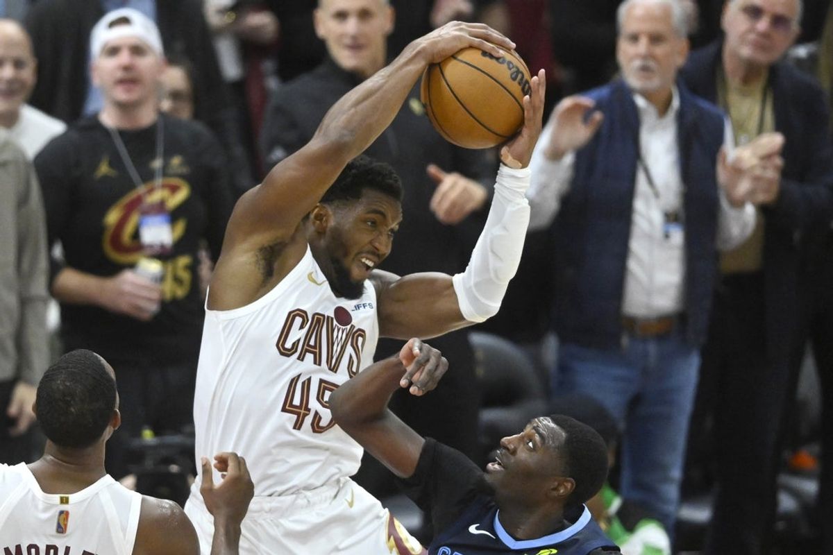 Nov 15, 2025; Cleveland, Ohio, USA; Cleveland Cavaliers guard Donovan Mitchell (45) rebounds beside Memphis Grizzlies guard Vince Williams Jr. (5) in the fourth quarter at Rocket Arena. Mandatory Credit: David Richard-Imagn Images