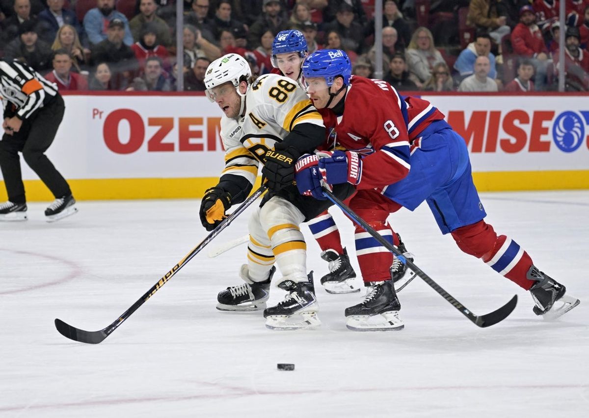 Nov 15, 2025; Montreal, Quebec, CAN; Montreal Canadiens defenseman Mike Matheson (8) takes the puck away from Boston Bruins forward David Pastrnak (88) during the first period at the Bell Centre. Mandatory Credit: Eric Bolte-Imagn Images