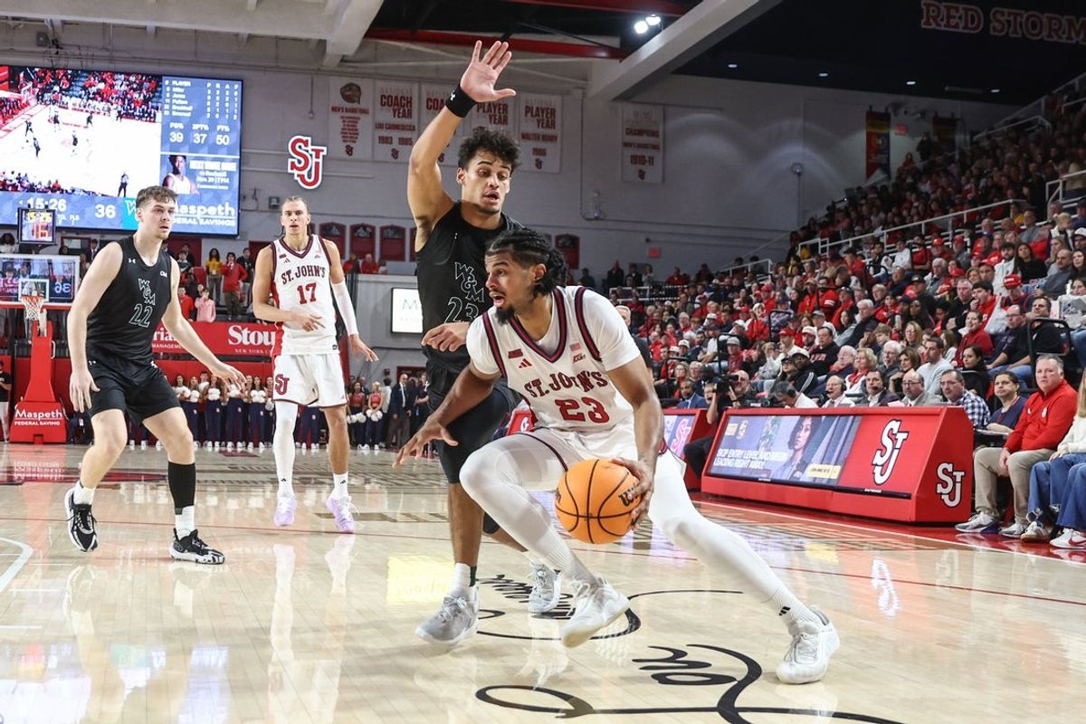 Nov 15, 2025; Queens, New York, USA;  St. John's Red Storm forward Bryce Hopkins (23) drives past  William & Mary Tribe forward Jo'El Emanuel (23) in the second half at Carnesecca Arena. Mandatory Credit: Wendell Cruz-Imagn Images