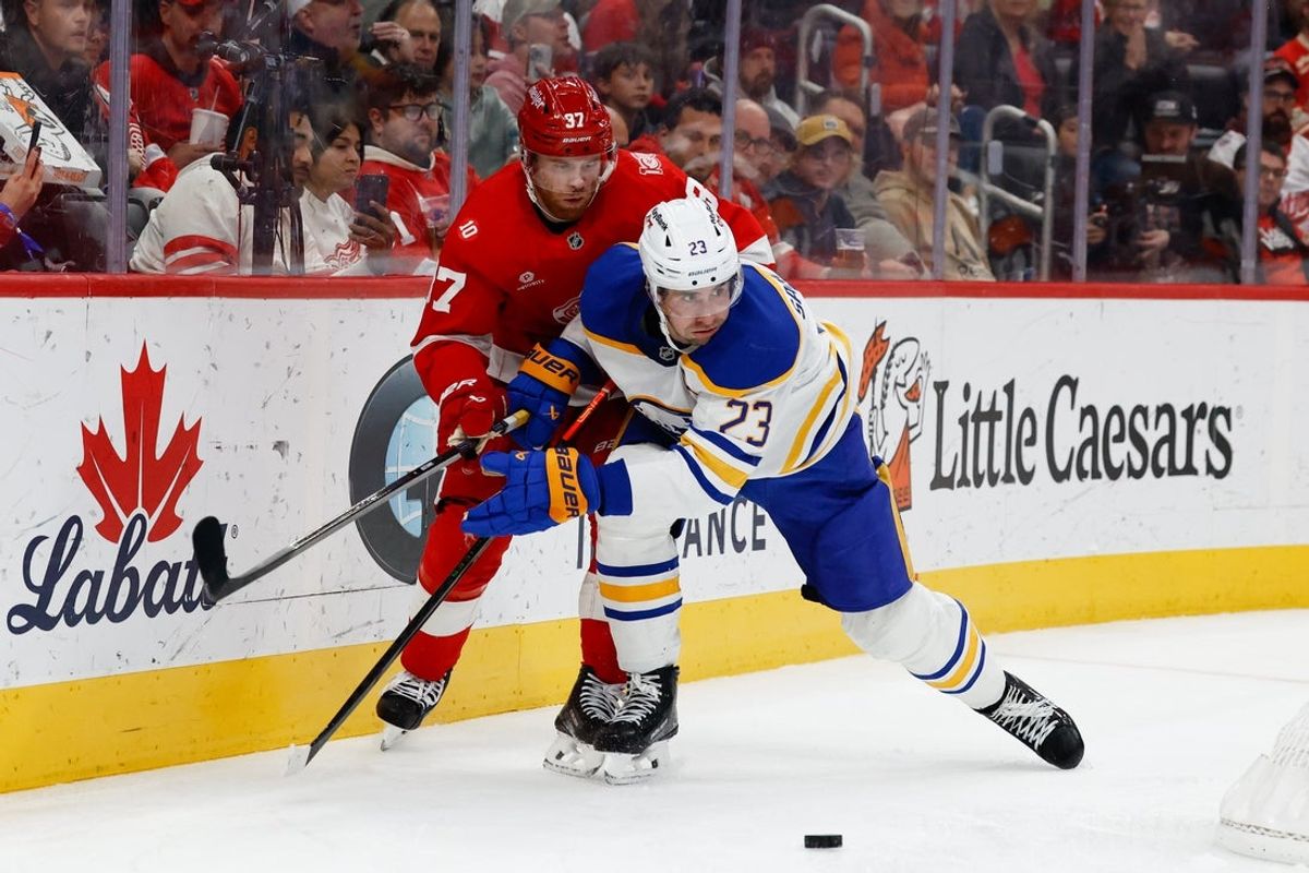 Nov 15, 2025; Detroit, Michigan, USA;  Detroit Red Wings left wing J.T. Compher (37) and Buffalo Sabres defenseman Mattias Samuelsson (23) battle for the puck in the second period at Little Caesars Arena. Mandatory Credit: Rick Osentoski-Imagn Images