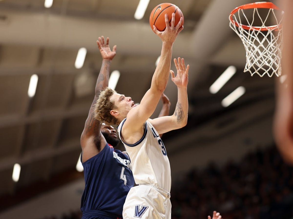 Nov 15, 2025; Villanova, Pennsylvania, USA; Villanova Wildcats forward Matt Hodge (33) drives for a shot agains Duquesne Dukes forward John Hugley IV (4) during the first half at William B. Finneran Pavilion. Mandatory Credit: Bill Streicher-Imagn Images