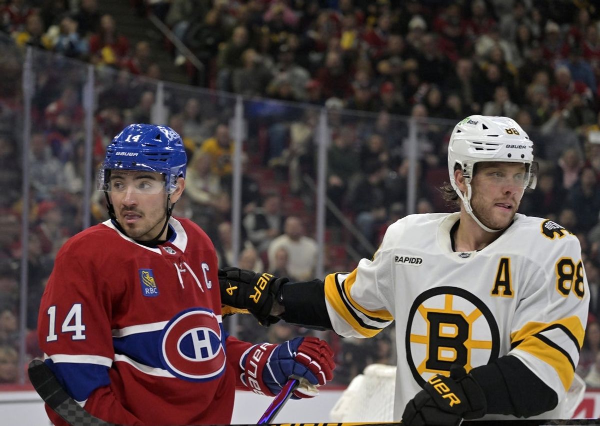 Nov 15, 2025; Montreal, Quebec, CAN; Montreal Canadiens forward Nick Suzuki (14) and Boston Bruins forward David Pastrnak (88) go their seperate ways during the third period at the Bell Centre. Mandatory Credit: Eric Bolte-Imagn Images