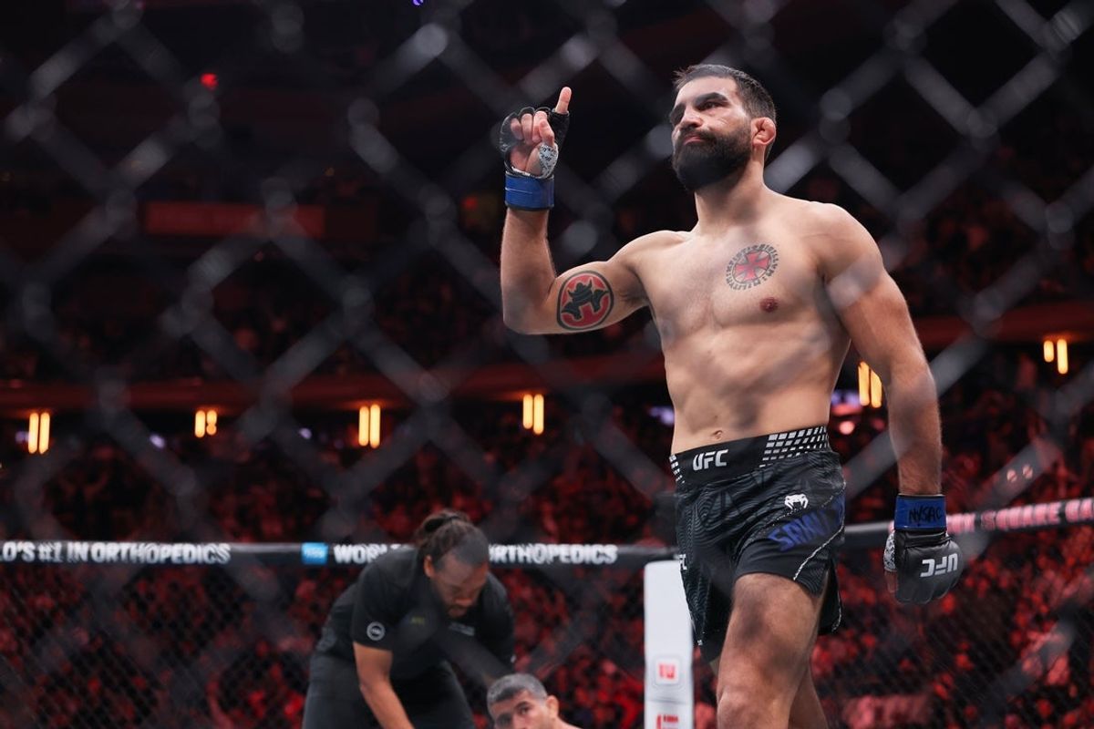 Nov 15, 2025; New York, NY, UNITED STATES; Benoit Saint Denis (blue gloves) reacts after defeating Beneil Dariush (red gloves) in the lightweight bout during UFC 322 at Madison Square Garden. Mandatory Credit: Ed Mulholland-Imagn Images